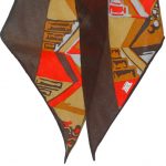 Long Lberty of London silk scarf with a brown border and abstract design in red, mustard and grey