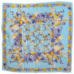 Liberty silk scarf with a light blue background and a vibrant floral design