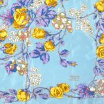 Liberty silk scarf with a light blue background and a vibrant floral design