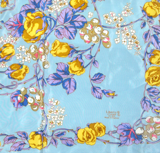 Liberty silk scarf with a light blue background and a vibrant floral design
