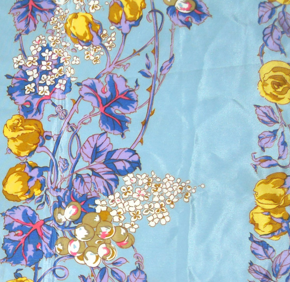 Liberty silk scarf with a light blue background and a vibrant floral design
