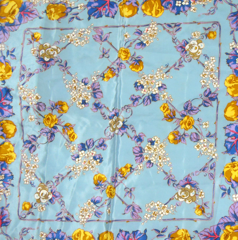 Liberty silk scarf with a light blue background and a vibrant floral design