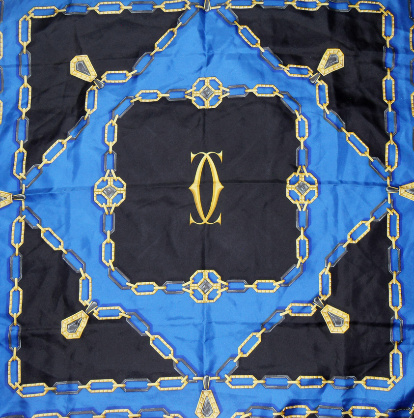 Cartier Silk scarf in a blue, black and gold design with the logo in the centre