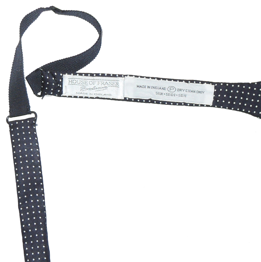 Silk self tie bow tie with a navy blue background and a small white dot design