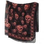 Long skull design scarf by Alexander McQueen, orange on black