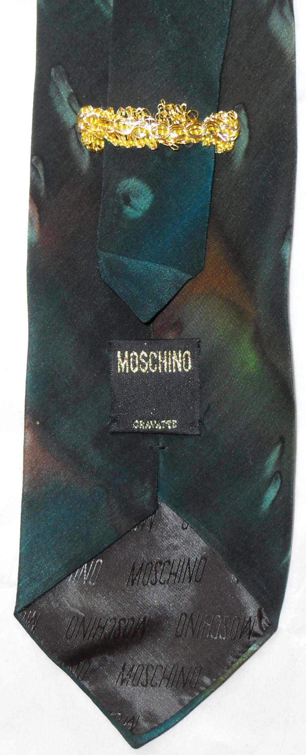 Vintage Moschino silk tie with a dark green background