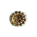 Gold tone brooch set with green stones