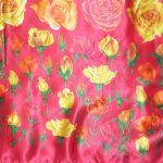 Tendenze rose design silk scarf on a red background