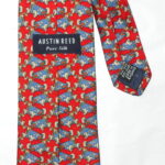 Austin Reed red background silk tie with a design of a blue racing car