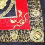 Red and gold classical design with a black border silk scarf with hand rolled edges