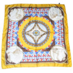 Silk scarf with hand rolled edges and a gold border with a classic central design in grey, blue and red.