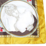 Silk scarf with hand rolled edges and a gold border with a classic central design in grey, blue and red.