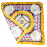 Silk scarf with hand rolled edges and a gold border with a classic central design in grey, blue and red.
