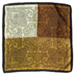 Silk pocket square with a black border and a design in brown, light and nd dark gold
