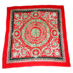 Jacquard silk scarf with a red border and central design on a red background