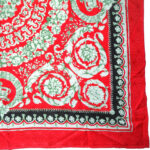Jacquard silk scarf with a red border and central design on a red background