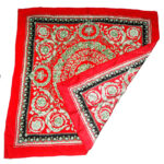 Jacquard silk scarf with a red border and central design on a red background
