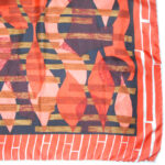 Orange and white border silk scarf wiht a central deisgn in ornage black and brown