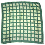 Vintage silk scarf with hand rolled edges, a dark green backgrounda nd a light green design
