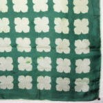 Vintage silk scarf with hand rolled edges, a dark green backgrounda nd a light green design