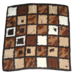 Hand rolled edge silk scarf with adesign in shades of brown and cream