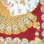 Xiang Mei fan design silk scarf with a dark red border and the central design in shades of pink, blue and gold