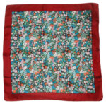 Liberty of London silk scarf with a dark red border and a central design of flowers in different colours