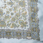Liberty of London silk scarf with a pale blue border and background and a detailed paisley design