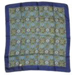 Liberty of London silk scarf with a dark blue border and a detailed central design in blue, gold and mauve