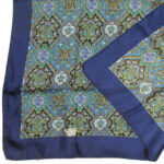 Liberty of London silk scarf with a dark blue border and a detailed central design in b