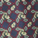 Yellow flower design silk tie on a dark blue background with a red diamond design, made in USA
