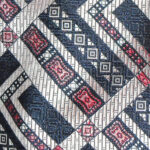 Christian Dior silk tie with a textured silk design in navy, silver and red