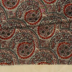 Vintage long rayon acetate scarf with a detailed design on a pale gold background