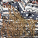 Long silk scarf with tasseled ends and a design in cream, dark blue and brown