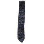 Liberty of London hand printed narrow silk tie with a blue background and a design in dark blue, red and yellow