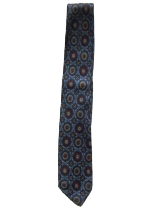 Liberty of London hand printed narrow silk tie with a blue background and a design in dark blue, red and yellow