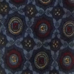 Liberty of London hand printed narrow silk tie with a blue background and a design in dark blue, red and yellow