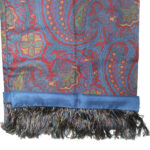 Long silk evening scrf with a blue background and border and a red, yellow and green design