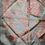 Dark olive border silk square with a design in red, gold and blue