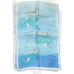 Vera long silk scarf with a blue background and a design of fishnig boats