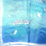 Vera long silk scarf with a blue background and a design of fishnig boats
