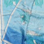 Vera long silk scarf with a blue background and a design of fishnig boats